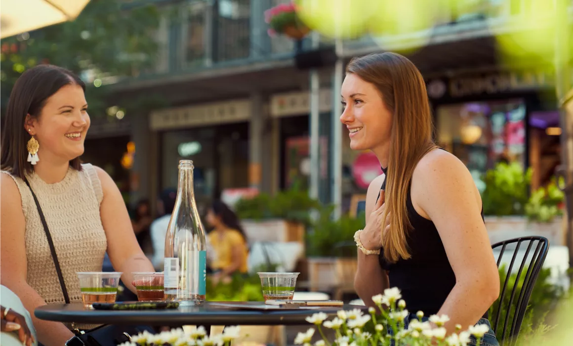 two women chatting at a café